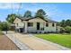 Charming home with a paved driveway and a well-maintained lawn with mature trees at 4020 Ester Sw Dr, Atlanta, GA 30331