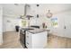 Modern kitchen with a granite island including a cooktop and stylish lighting fixtures at 4020 Ester Sw Dr, Atlanta, GA 30331