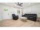Bright living room featuring neutral decor, light hardwood floors, and a view of the front door at 4020 Ester Sw Dr, Atlanta, GA 30331
