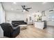 Inviting living space features a modern ceiling fan, an island, and wood-look floors at 4020 Ester Sw Dr, Atlanta, GA 30331