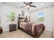 Cozy main bedroom with a ceiling fan, natural light from windows, and modern furnishings at 4020 Ester Sw Dr, Atlanta, GA 30331