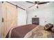 Main bedroom features a ceiling fan and a rustic wood-paneled sliding door at 4020 Ester Sw Dr, Atlanta, GA 30331