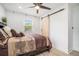 Well-lit main bedroom showcases a ceiling fan and barn door at 4020 Ester Sw Dr, Atlanta, GA 30331