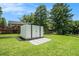 Backyard view of white shed with black trim, black chainlink fence, and pea gravel at 4020 Ester Sw Dr, Atlanta, GA 30331