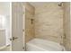 Bathroom features tiled shower and tub with a built-in shelf and a door at 6980 Roswell Rd # P6, Atlanta, GA 30328