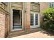 Exterior entry and patio featuring gray trim, a brick facade, and double doors at 6980 Roswell Rd # P6, Atlanta, GA 30328