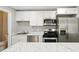 Modern kitchen features stainless steel appliances, white cabinets, and marble countertops at 6980 Roswell Rd # P6, Atlanta, GA 30328