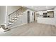 Open-concept living space featuring staircase, light gray walls, and vinyl plank flooring at 6980 Roswell Rd # P6, Atlanta, GA 30328