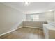 Upstairs loft area includes wood flooring, a modern dresser, and a window at 6980 Roswell Rd # P6, Atlanta, GA 30328