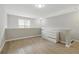 Upstairs loft area includes wood flooring, a modern dresser, and a window at 6980 Roswell Rd # P6, Atlanta, GA 30328