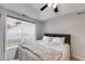 This comfortable bedroom features a large window, ceiling fan and neutral decor at 102 Natalie Ct, Dallas, GA 30157