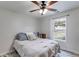 This bedroom features a ceiling fan, large window, and a bed with comfy blankets at 102 Natalie Ct, Dallas, GA 30157