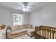 Cozy bedroom features a comfortable seating area, crib, and lots of natural light at 102 Natalie Ct, Dallas, GA 30157