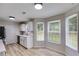 Eat-in kitchen featuring white cabinetry, stainless steel appliances, and plenty of natural light at 102 Natalie Ct, Dallas, GA 30157