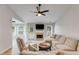 Spacious living room featuring vaulted ceiling, fan, fireplace, and backyard access at 102 Natalie Ct, Dallas, GA 30157