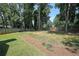 Expansive backyard with a wooden fence, mature trees, and a slight slope at 1313 Old Countryside Cir, Stone Mountain, GA 30083