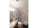 Traditional bathroom featuring granite countertop, patterned shower curtain, and decorative mirror at 1313 Old Countryside Cir, Stone Mountain, GA 30083