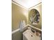 Bathroom with white sink and trim with a round mirror at 1313 Old Countryside Cir, Stone Mountain, GA 30083