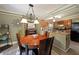 The dining area features a chandelier, wood table, and an adjacent kitchen at 1313 Old Countryside Cir, Stone Mountain, GA 30083