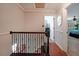 Upstairs hallway featuring hardwood floors, modern railing, and access to rooms at 1313 Old Countryside Cir, Stone Mountain, GA 30083