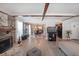 Open-concept living room featuring a fireplace, adjacent dining area, and hardwood floors throughout at 1313 Old Countryside Cir, Stone Mountain, GA 30083