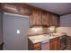 The bar features wood cabinets, granite countertop and stainless dishwasher and sink at 297 Collegiate Dr, Powder Springs, GA 30127