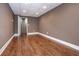A finished room in the basement with wood floors and a door, ready for your personal touch at 297 Collegiate Dr, Powder Springs, GA 30127