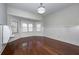 Bright bedroom with hardwood floors, paneled walls, many windows, and a cozy, inviting atmosphere at 297 Collegiate Dr, Powder Springs, GA 30127