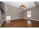 Spacious bedroom featuring hardwood floors, a modern ceiling fan, and a window offering natural light at 297 Collegiate Dr, Powder Springs, GA 30127