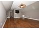 Large bedroom with hardwood flooring, modern ceiling fan, and a mounted TV at 297 Collegiate Dr, Powder Springs, GA 30127