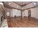 Bedroom with hardwood floors, a ceiling fan, a fireplace, and access to outdoor space at 297 Collegiate Dr, Powder Springs, GA 30127