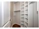 Organized closet featuring custom white shelving and hardwood floors, perfect for maximizing storage space at 297 Collegiate Dr, Powder Springs, GA 30127