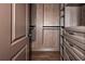 Custom walk-in closet with built in wooden shelving, drawers and custom hanging racks at 297 Collegiate Dr, Powder Springs, GA 30127