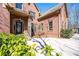 Elegant brick home exterior with a beautifully landscaped front yard and stone accents on the column and entrance at 297 Collegiate Dr, Powder Springs, GA 30127