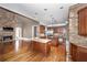 Gourmet kitchen with granite countertops, dual islands, stainless steel appliances, and a stone fireplace at 297 Collegiate Dr, Powder Springs, GA 30127