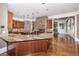 Kitchen with granite counters, custom cabinets, stainless appliances and an open layout with stone fireplace at 297 Collegiate Dr, Powder Springs, GA 30127
