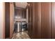 Laundry room with front load washer/dryer and custom shelving at 297 Collegiate Dr, Powder Springs, GA 30127
