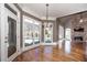 Bright sunroom with hardwood floors, pool view, and stone fireplace at 297 Collegiate Dr, Powder Springs, GA 30127