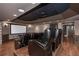 Home movie theater with projector screen, black drop ceiling, and tiered leather recliner seating at 297 Collegiate Dr, Powder Springs, GA 30127