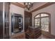 Custom walk-in closet with decorative mirror, chandelier, island and window at 297 Collegiate Dr, Powder Springs, GA 30127
