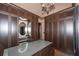 Spacious walk-in closet with custom shelving, chandelier and decorative mirror at 297 Collegiate Dr, Powder Springs, GA 30127