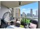 Relaxing balcony with city skyline views, comfortable seating, lush plants and modern décor at 3338 Peachtree Ne Rd # 1507, Atlanta, GA 30326