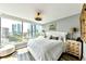 Bright bedroom with large windows showcasing expansive city views, hardwood floors, and a stylish white bed frame at 3338 Peachtree Ne Rd # 1507, Atlanta, GA 30326