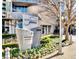 Landscaped building entrance with modern signage, decorative plants, and brick sidewalk at 3338 Peachtree Ne Rd # 1507, Atlanta, GA 30326