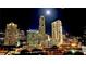 City skyline featuring several high-rise buildings, city lights and bright moon at night at 3338 Peachtree Ne Rd # 1507, Atlanta, GA 30326
