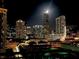 Stunning night view of a vibrant city skyline with illuminated skyscrapers under a bright moon at 3338 Peachtree Ne Rd # 1507, Atlanta, GA 30326