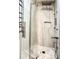 Stylish shower stall featuring stone tile, rainfall shower head, and built-in niche for toiletries at 3338 Peachtree Ne Rd # 1507, Atlanta, GA 30326