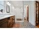 Elegant bathroom with a glass-enclosed shower, double vanity, and patterned tile flooring at 563 Ralph Mcgill Ne Blvd, Atlanta, GA 30312