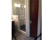 Modern bathroom featuring glass shower, dark wood door, decorative floor tiles, and marble vanity at 563 Ralph Mcgill Ne Blvd, Atlanta, GA 30312