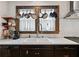 Kitchen with white countertops, stainless steel faucet, and dark cabinets with hanging pot rack at 563 Ralph Mcgill Ne Blvd, Atlanta, GA 30312
